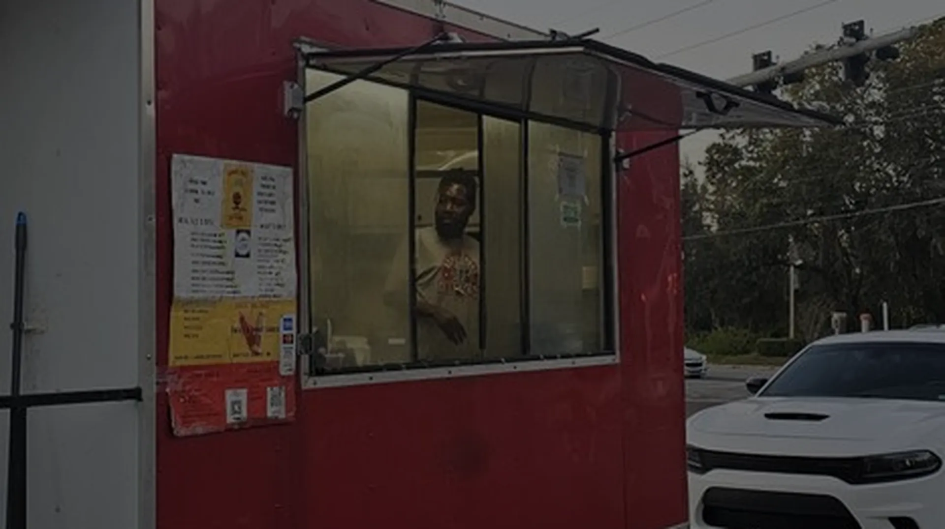 The red Ronnie Ron's BBQ trailer with service window open